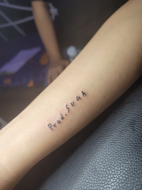 a woman's arm with the word russian tattooed on her left forearm and foot