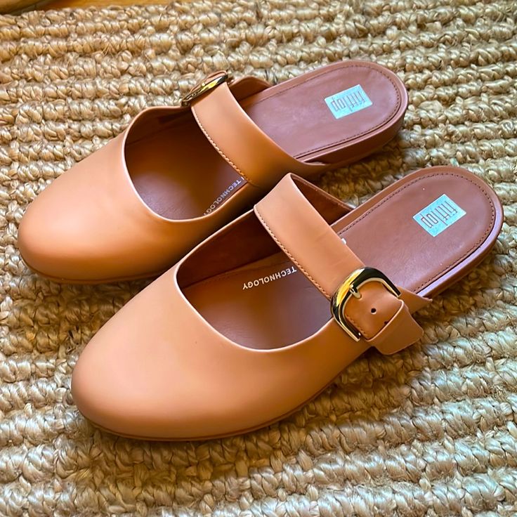 Fitflop Allegro Mules In Blush (Tan) Leather. Size 8 With An Adjustable Strap. Never Worn Except To Try On. Original Box. Incredibly Comfortable And True To Size. Comfortable Flat Mules With Buckle Closure, Trendy Round Toe Mules With Buckle Closure, Trendy Mules With Buckle Closure And Round Toe, Everyday Mules With Branded Insole And Round Toe, Everyday Round Toe Slippers For Spring, Brown Flat Slippers With Buckle Closure, Trendy Leather Flat Mules, Beige Flat Mules With Buckle Closure, Flat Mules With Buckle Closure