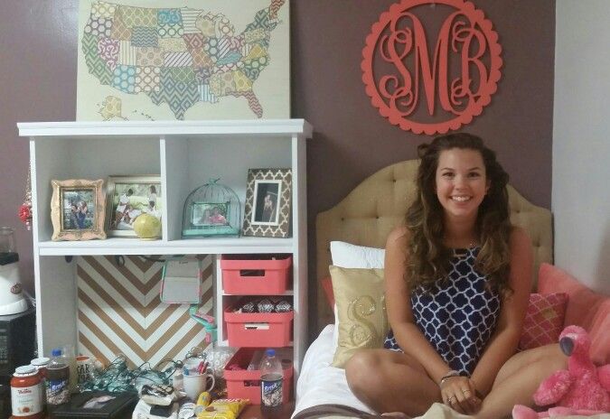 a woman sitting on top of a bed next to a teddy bear and other items