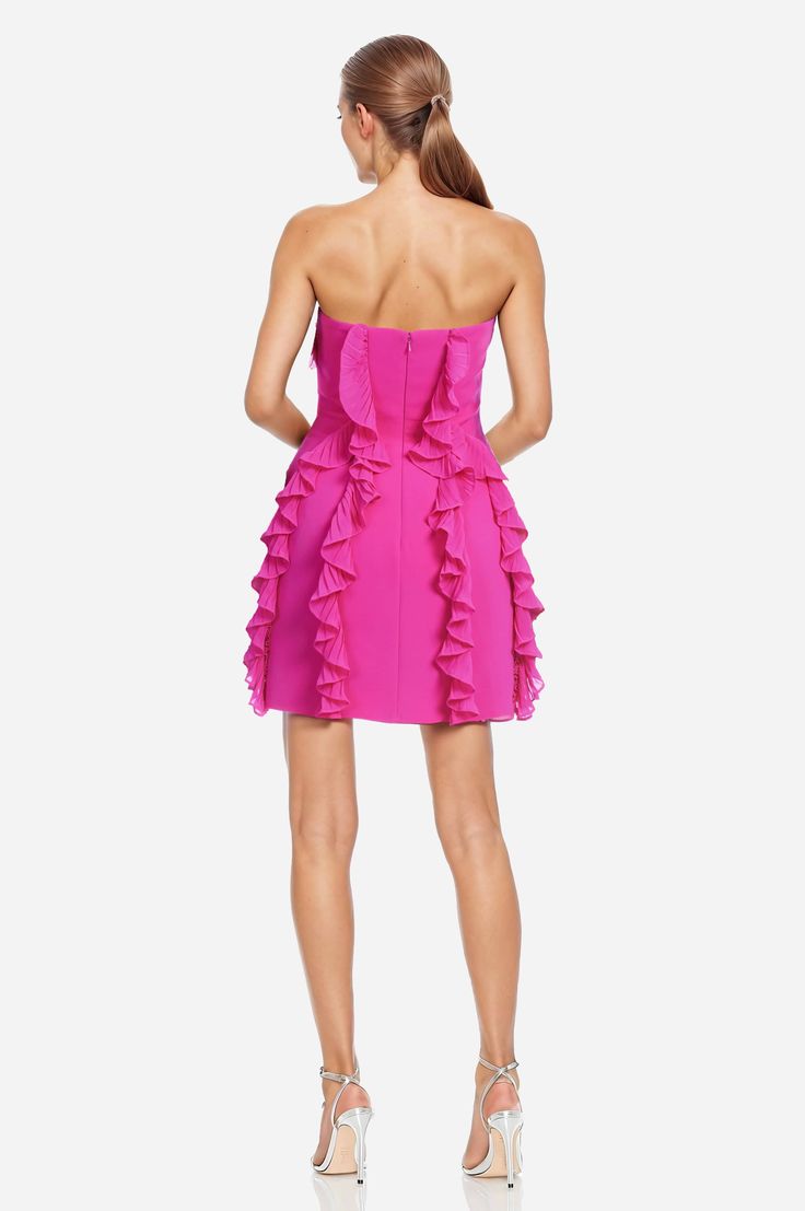 Party in the front AND the back… The Khefri is bound to wow everyone - at every angle. From the front, ruffles detail the bodice while they gracefully cascade down the bottom of the dress. And the back does not disappoint - two defined lines of ruffle give this mini dress the finish that it needs. Peeking out around the hemline is a layer of tulle for the perfect flounce and bounce. No need for accessories, the dress says it all. Throw it on for a girl's night or date night out or that showstopp Pre-draped Sleeveless Evening Dress With Ruffles, Evening Dresses With Ruched And Ruffled Straps, Prom Dress With Ruffled Skirt And Straps, Party Dress With Pleated Bodice And Ruffled Straps, Evening Dresses With Ruched Bodice And Ruffled Straps, Sleeveless Prom Dress With Ruffle Hem, Pre-draped Sleeveless Dress With Ruffles, Flirty Strapless Dress With Ruffles And Fitted Bodice, Chiffon Prom Dress With Ruffled Skirt