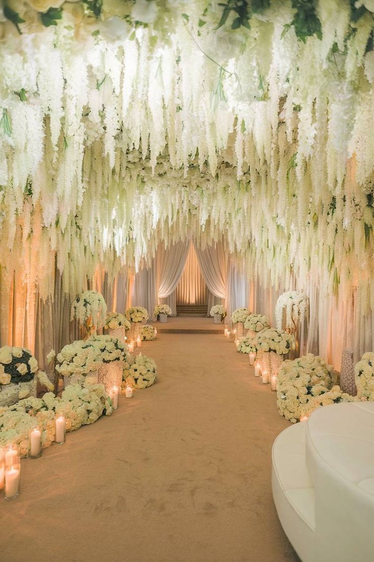 Floral wedding entrance with cascading white blooms and candles. Wedding Venues Indoor Elegant, Floral Tunnel, Wedding Venue Decor, Luxury Wedding Ideas, Lavish Wedding, Dramatic Entrance, Extravagant Wedding, All White Wedding, Wedding Entrance