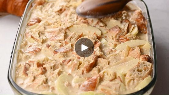 a casserole dish with apples and walnuts in it is being spooned