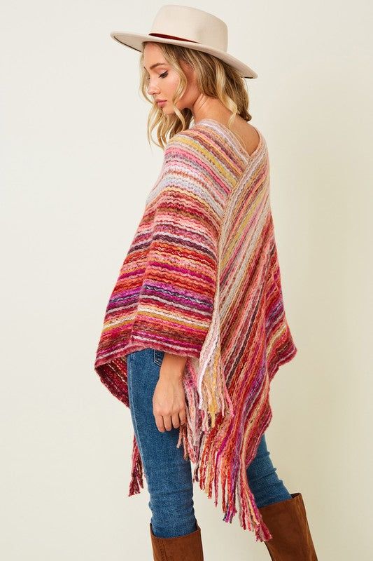 Acrylic. available in blue One Size Casual Poncho For Spring, Casual Shawl Poncho For Spring, Trendy One-size Poncho For Spring, One Size Shawl Poncho For Spring, Casual Fall Shawl Poncho, Casual Shawl Poncho For Fall, Casual Pink Poncho, Casual Multicolor Fall Poncho, Casual Multicolor Cape For Fall