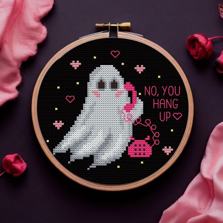 a cross stitch pattern with a white ghost holding a pink heart and saying, no you hang up