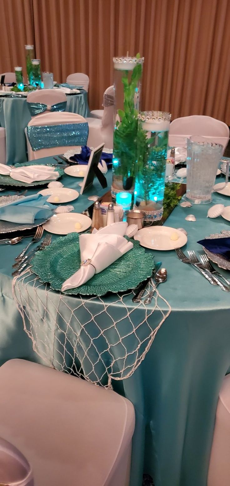 the table is set with plates, silverware and napkins for an elegant dinner