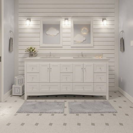 a white bathroom with two sinks and mirrors