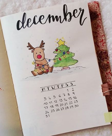 a calendar with a drawing of a reindeer next to a christmas tree