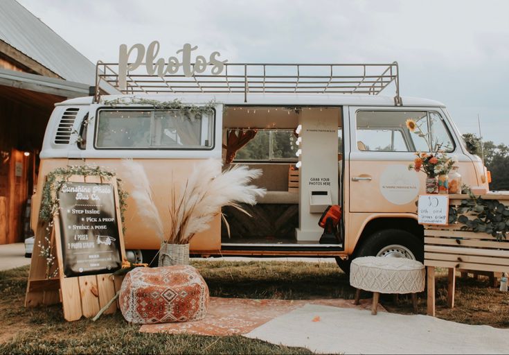 an old vw bus is decorated with flowers and greenery for a rustic wedding