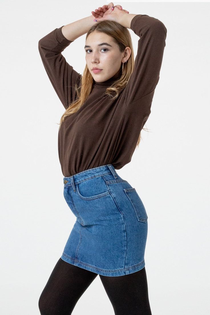 Our denim mini skirt is here, made of 100% cotton, heavy denim. This style features two front pockets and two in the back and is fitted throughout. Pair this style with tights and your favorite turtleneck style for the winter and wear it year-round with a cropped baby tee in the summer. This garment runs true-to-size and has a high waisted fit. Made in Los Angeles, Calif. Our experienced sewers earn up to $25 an hour and no less than $16; additionally workers have healthcare benefits for less th Fitted High Waist Denim Skirt For Fall, Fitted High-waist Denim Skirt For Fall, Fitted Dark Wash Mini Skirt For Fall, Trendy Denim Pencil Skirt For Fall, Stretch Cotton Denim Skirt For Fall, High Rise Dark Wash Mini Skirt For Fall, Fitted Denim Skirt In Medium Wash For Fall, Trendy Fitted Denim Skirt For Winter, Stretch Denim Mini Skirt For Fall