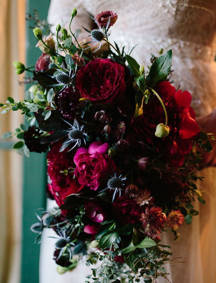 a bride holding a bouquet of flowers in her hands