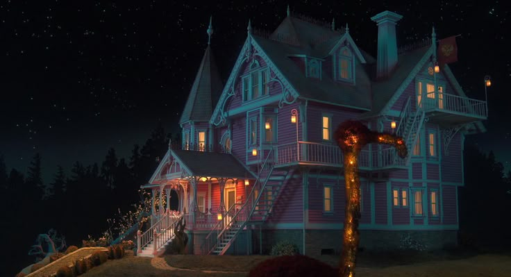 a large house is lit up at night with christmas lights on the porch and stairs