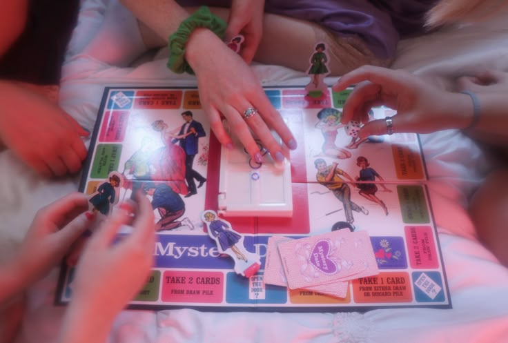 several people playing a board game on a bed