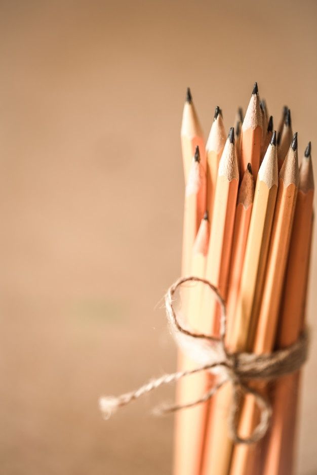 several pencils tied together with twine and string