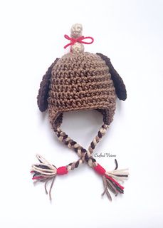 a crocheted dog hat with tassels on it