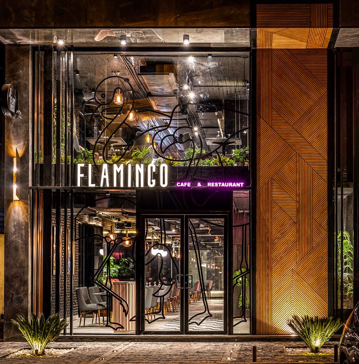 the entrance to flamingo cafe and restaurant at night