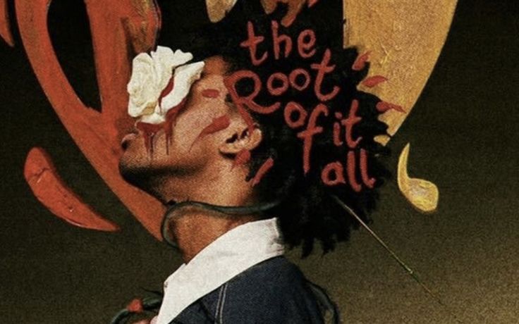 a man with dreadlocks standing in front of a sign that says the root it all