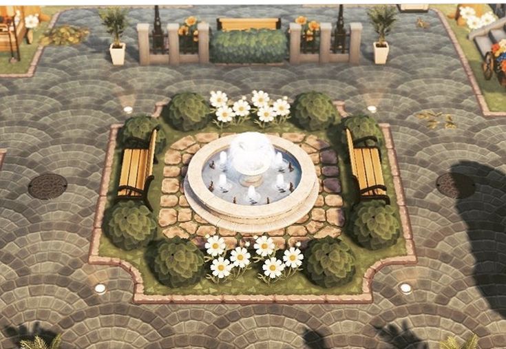 an aerial view of a park with benches, flowers and a fountain in the center