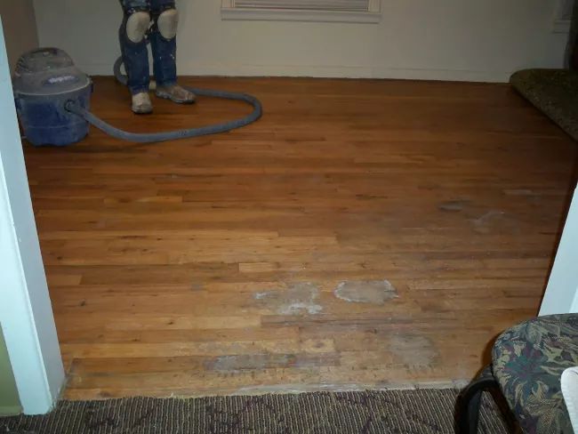 a room with wood floors and a fire hydrant on the floor next to it