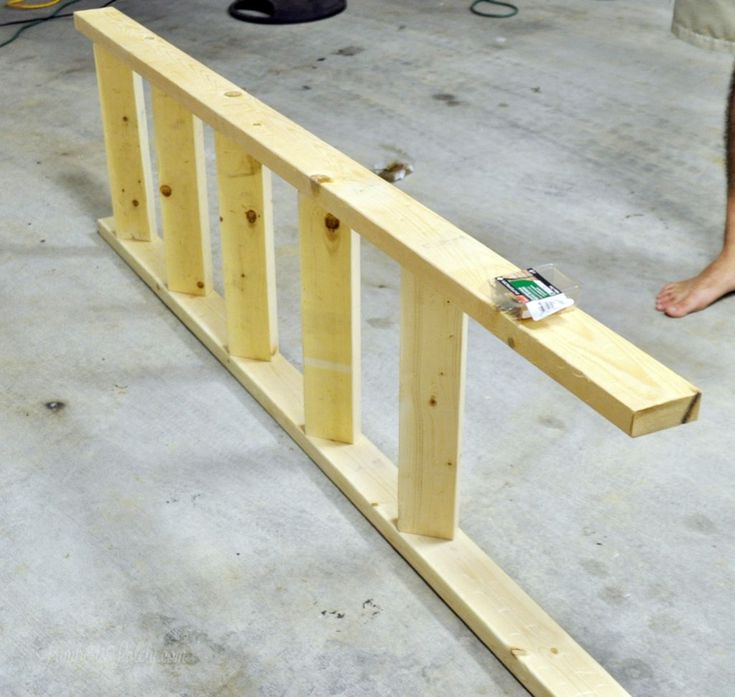 a person standing next to a wooden rail