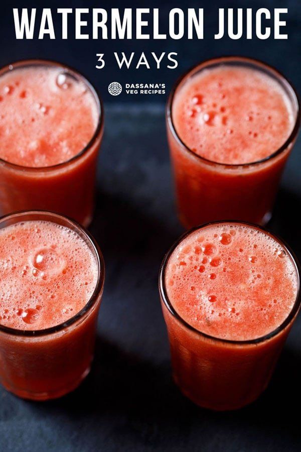 four glasses filled with watermelon juice sitting on top of a black countertop