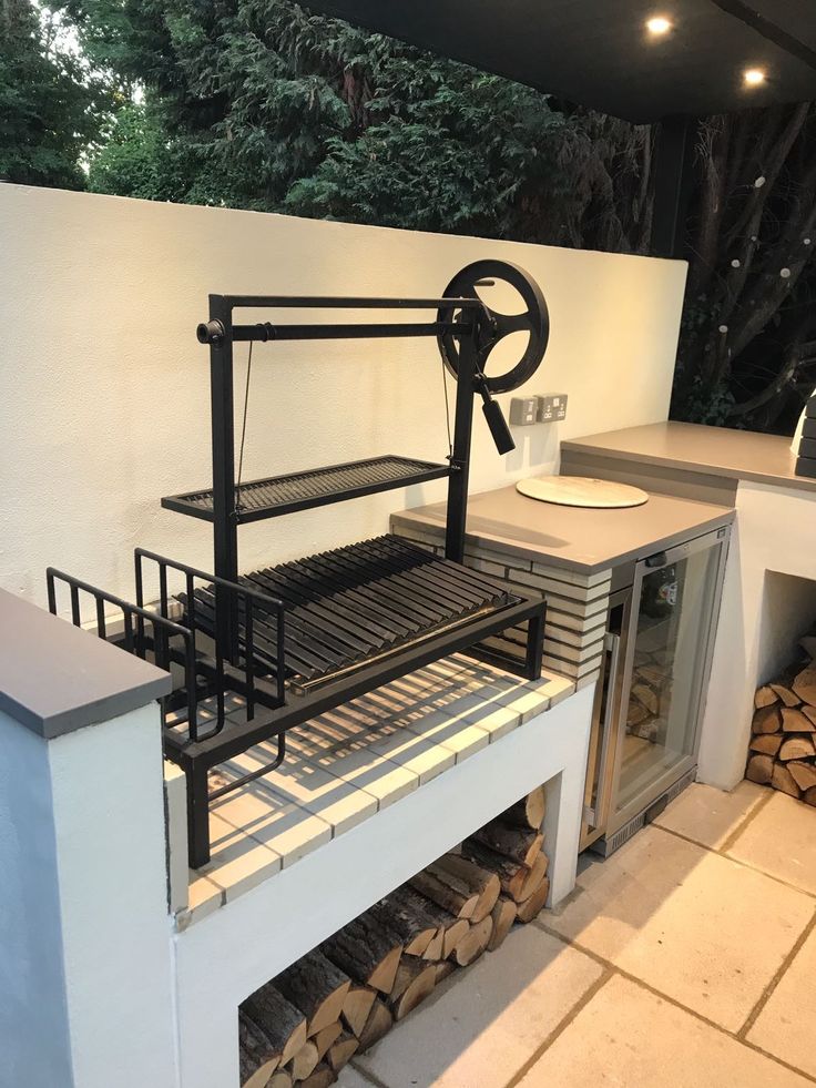 the grill is made out of wood and has an oven on it's side