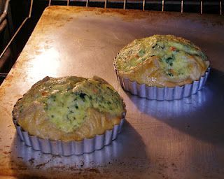 two muffins sitting on top of an oven pan