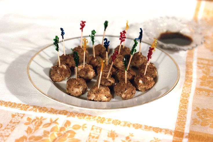 there are many small skewers with toothpicks in them on a plate