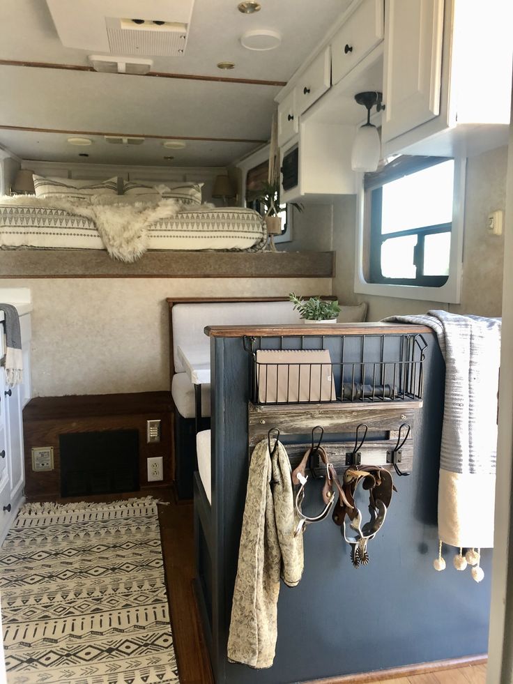 the inside of a camper with bunk beds and towels hanging on it's hooks