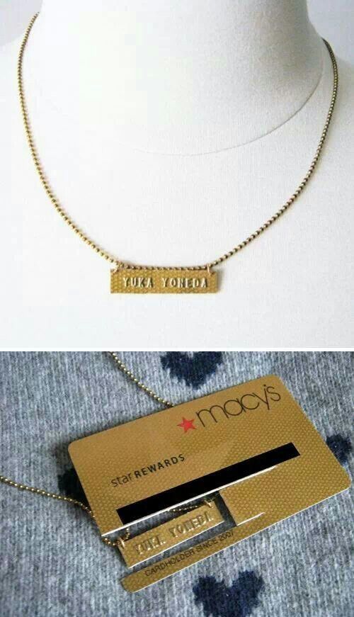 a necklace with a name tag on it and a gold card attached to the neck