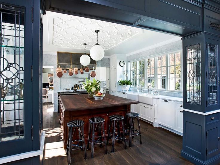 a kitchen with an island in the middle and lots of counter space on one side