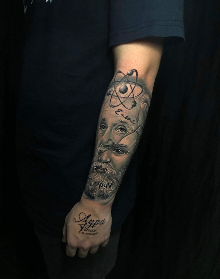 a man's arm with tattoos on it and an image of the face of jesus