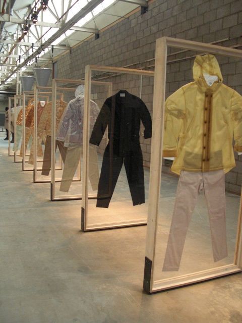 an assortment of clothing on display in glass cases