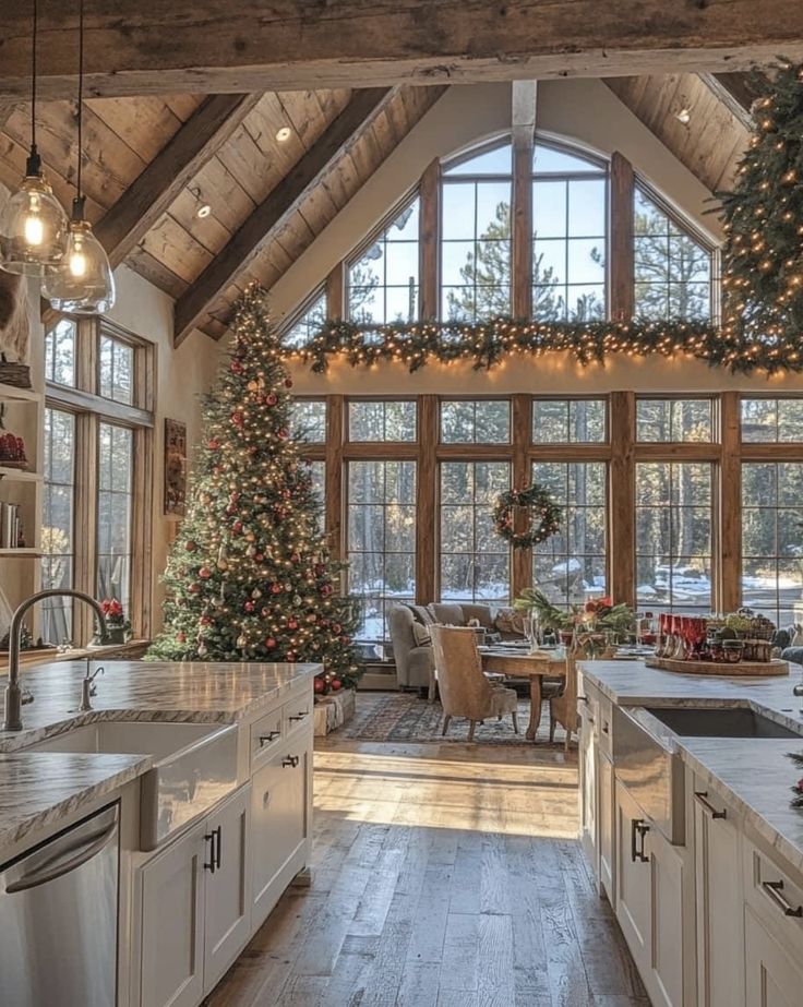 a kitchen decorated for christmas with lights on the windows and a tree in the center