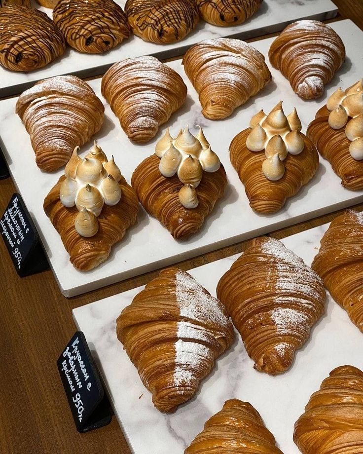 there are many different types of croissants on display