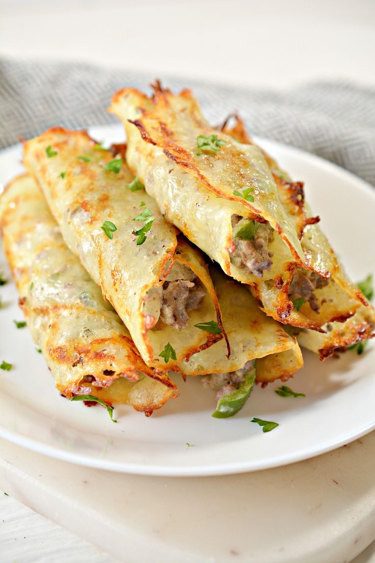 some food is on a white plate with green garnishes and parsley