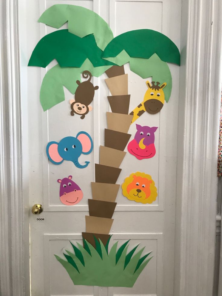 a door decorated with paper cut out animals and palm trees