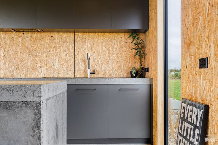 the kitchen is made out of concrete and wood