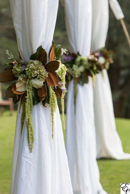 four white drapes with flowers and greenery on them