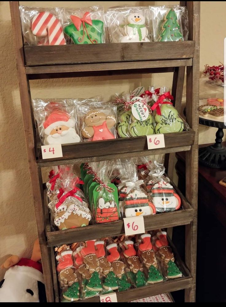 a shelf filled with lots of different types of christmas cookies and candies on display