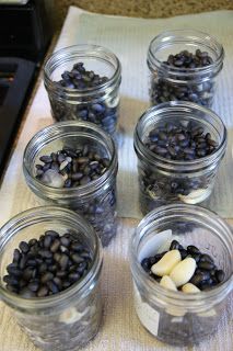 several jars filled with black beans and bananas