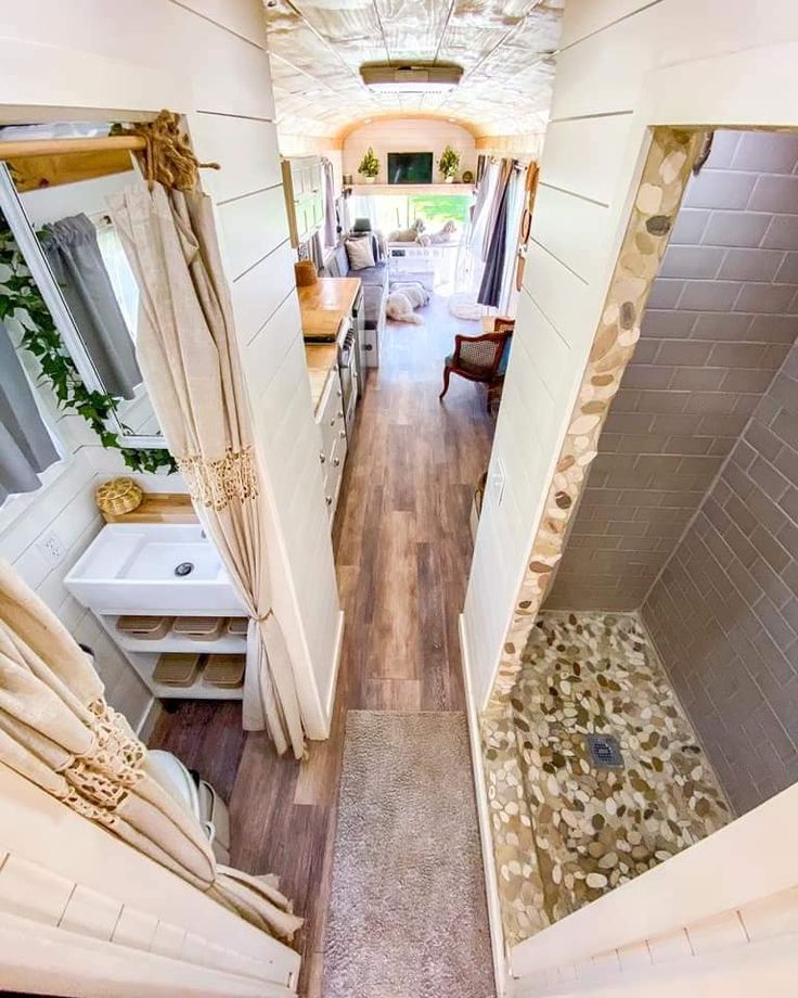 an aerial view of a narrow hallway leading to a bedroom and bathroom with wood flooring