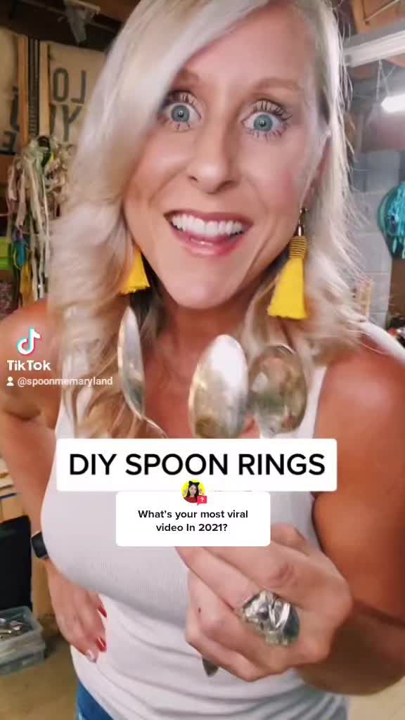 a woman holding spoons in her hands and smiling at the camera with words diy spoon rings