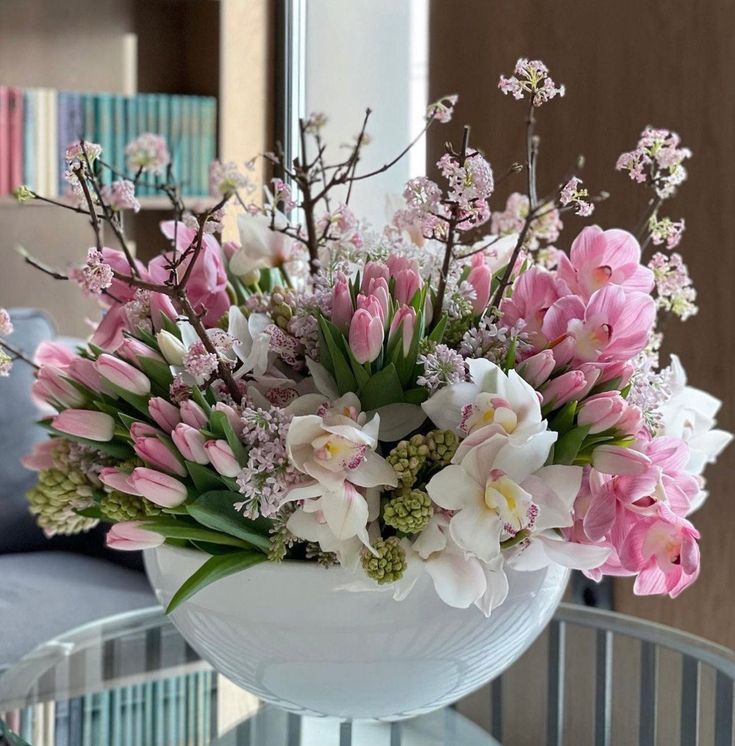 Large and stunning flower arrangement in ceramic vase that will elevate any space with it's vibrant blossoms. Pink tulips, spring branches, orchids and greenery will brighten your day bringing extra freshness to your home. Orchid Vase Centerpiece, Soft Pink Flower Arrangements, Tulips Flower Arrangements, Tulip Flower Arrangements, Tulip Arrangement Ideas, Holiday Party Centerpieces, Hotel Flower Arrangements, Luxury Flower Arrangement, Spring Branches