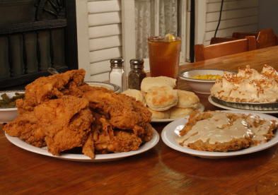 several plates of food on a wooden table