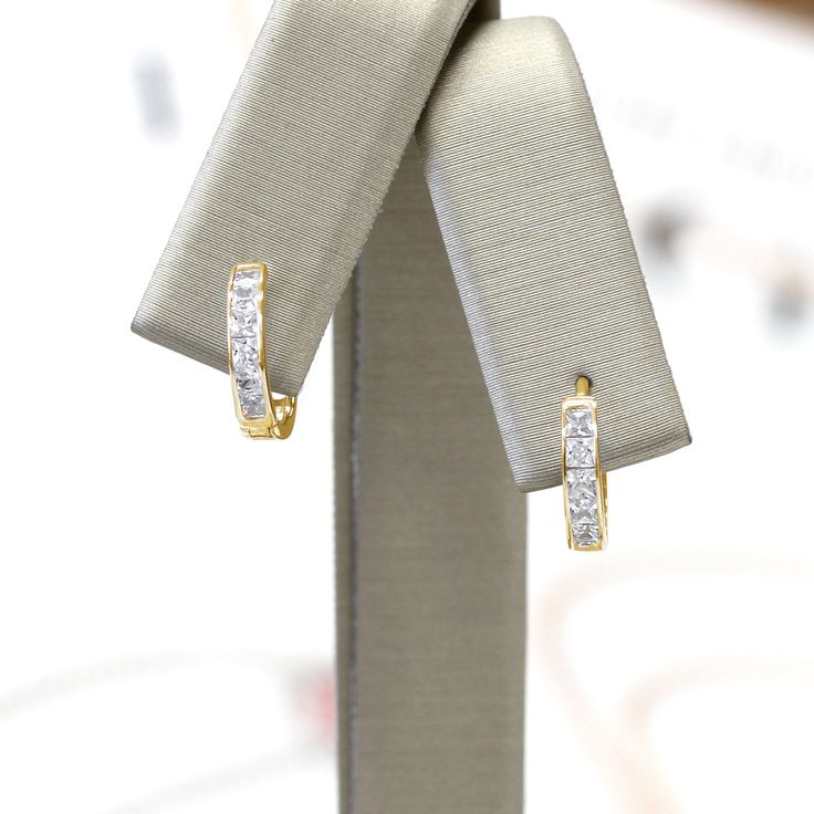 Classic and elegant, our bestselling 14K Gold Princess-Cut Cubic Zirconia Channel-Set Huggie Hoop Earrings add sparkle to the scenery. The perfect topper to your favorite little black dress but versatile enough to stack up with other huggie hoops or studs for a one-of-a-kind curated look that's all your own. Buy 14K Yellow Gold Princess-Cut Cubic Zirconia Channel-Set Huggie Hoop Earrings for yourself or as a gift. Find huggie earrings and jewelry on Etsy.com CHANNEL SETTING: A clean, contemporar Classic Gold Huggie Earrings Channel Set, Classic Gold Channel Set Huggie Earrings, Gold Hoop Earrings Channel Set As Gift, Gold Channel Set Hoop Earrings Gift, Fine Jewelry Huggie Earrings Channel Set, Fine Jewelry Channel Set Huggie Earrings, Yellow Gold Channel Set Huggie Earrings As Gift, Channel Set Huggie Earrings Gift, Gold Small Hoop Earrings With Channel Set