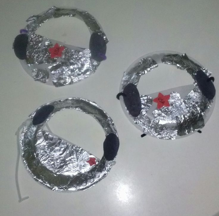 three pieces of tinfoil with headphones on them sitting on a counter top next to each other