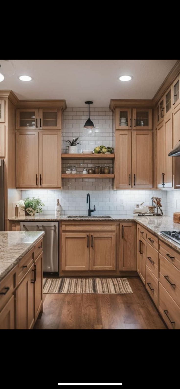 a kitchen with wooden cabinets and stainless steel appliances