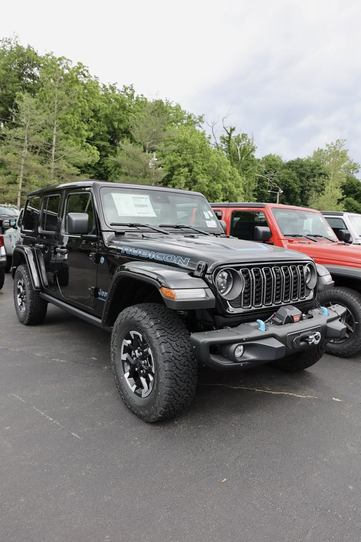 several jeeps are parked in a parking lot