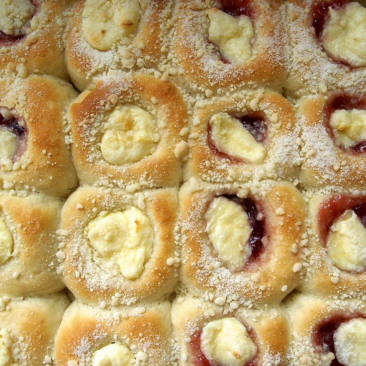 a close up view of pastries covered in powdered sugar