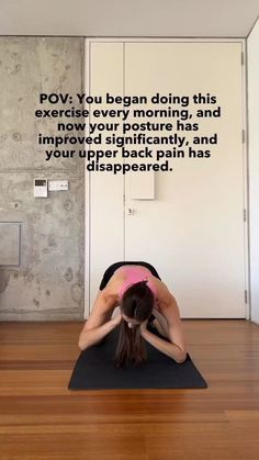 a woman is doing yoga in front of a wall with an inspirational quote on it